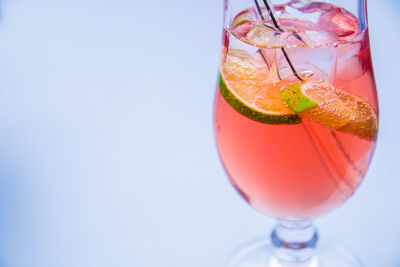 Close-up of wineglass against white background