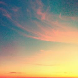 Low angle view of cloudy sky at sunset