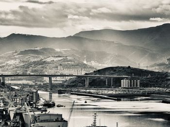 High angle view of river by city against sky