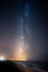 Scenic view of mountains against star field at night