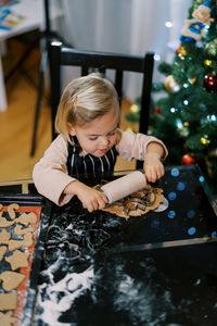 Portrait of boy playing with christmas tree