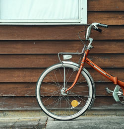 Bicycle parked against wall