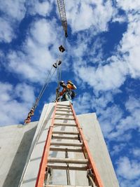 Low angle view of worker standing on building at construction site