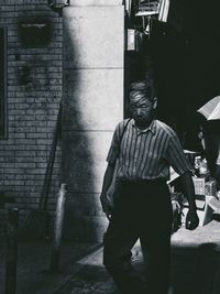 Man standing on street against buildings in city