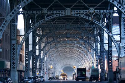 Low angle view of illuminated bridge at noon