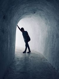 Full length of silhouette man standing in tunnel
