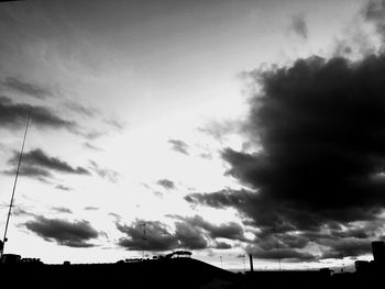 Low angle view of silhouette building against sky