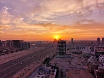 High angle view of buildings against sky during sunset