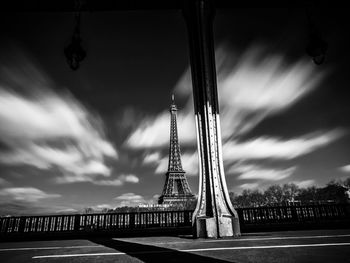 View of bridge over river against cloudy sky