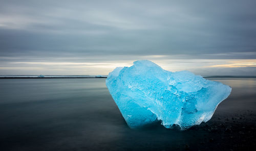 Frozen sea against sky