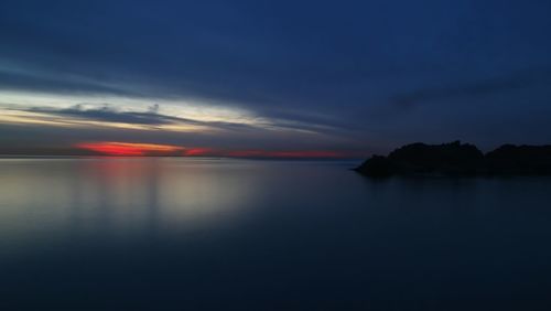 Scenic view of sea against sky at dusk