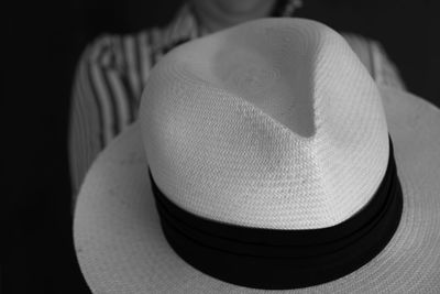 Close-up of hat against black background