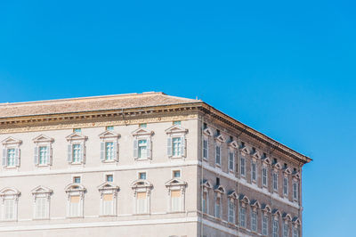 Low angle view of building against blue sky