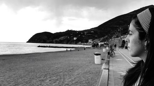 Woman on beach against sky