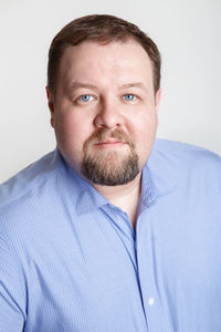 Close-up portrait of man against white background