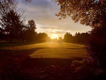 Scenic view of field against sky during sunset