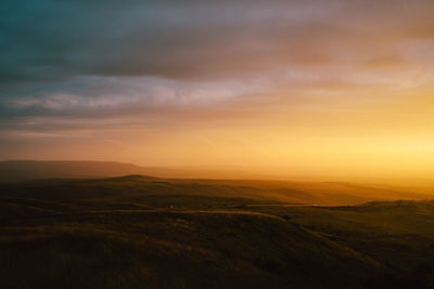 Scenic view of field against sky during sunset