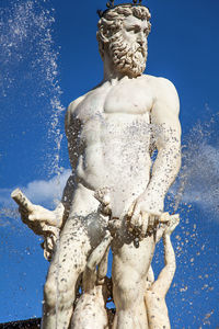 Low angle view of statue against blue sky