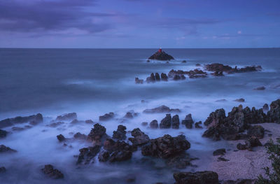 Scenic view of sea against sky at dusk