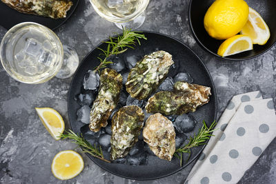 The festive table is served with black dishes with fresh oysters