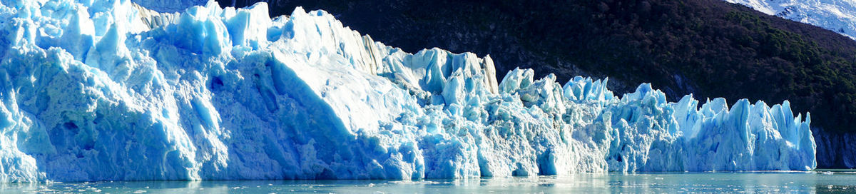 Panoramic view of frozen sea against landscape