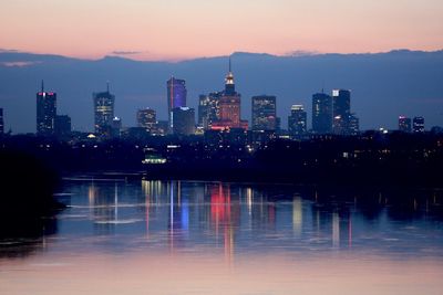 River leading towards illuminated city at night