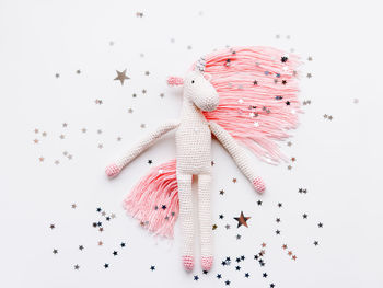 Cute fairy unicorn with pink mane. crocheted hand made toy with silver stars confetti. magic creatur