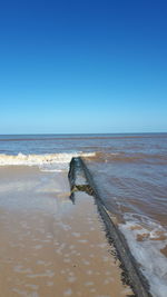 Scenic view of sea against clear blue sky