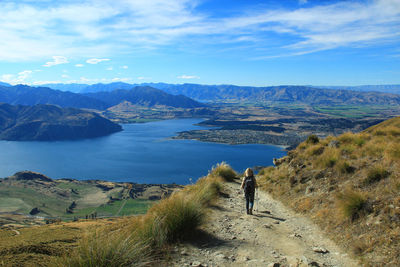 Rear view of woman walking on mountain