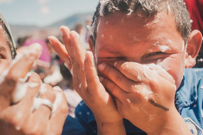 Close-up of hands holding water at beach