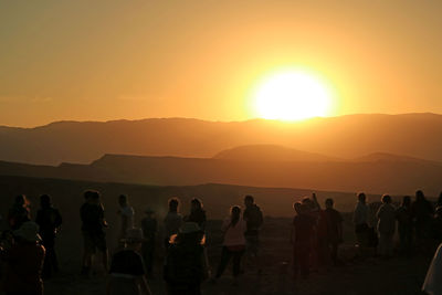 Group of people on mountain during sunset