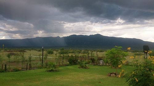 Scenic view of landscape against cloudy sky