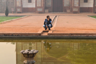 Full length of man sitting in water