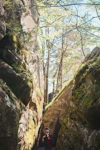 Rear view of man standing in cave