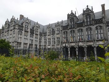 Low angle view of buildings in town against sky