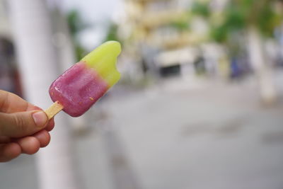 Close-up of hand holding ice cream cone