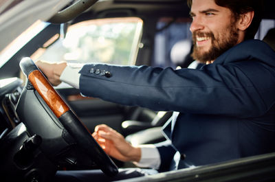 Midsection of businessman using mobile phone