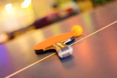 Close-up of ball and racket on table tennis