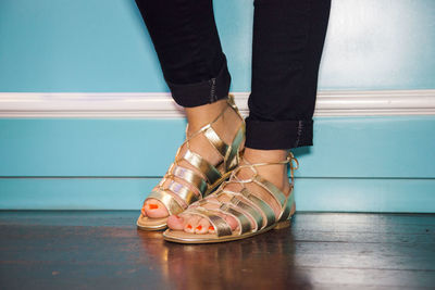 Low section of woman standing on tiled floor