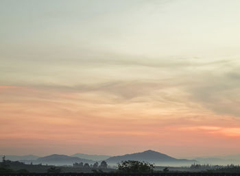 Scenic view of silhouette mountains against sky during sunset