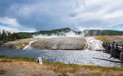 Scenic view of eruption by firehole river in midway geyser at yellowstone park