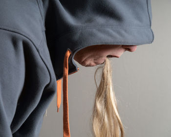 Side view of senior man with human hair in mouth