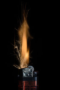 Close-up of cigarette lighter against black background