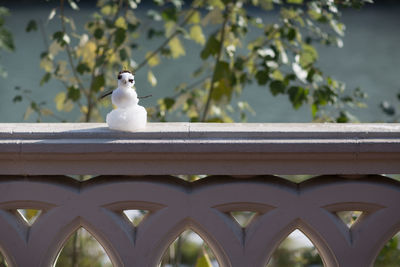 Close-up of sculpture against railing