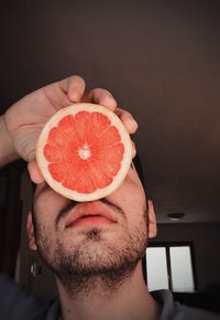 Close-up of man holding fruit