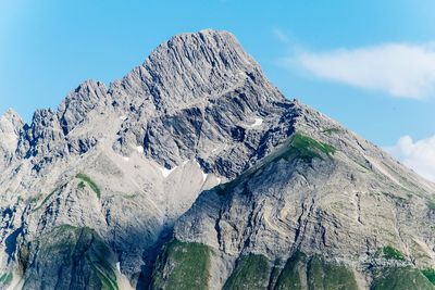 Low angle view of rocky mountains against sky