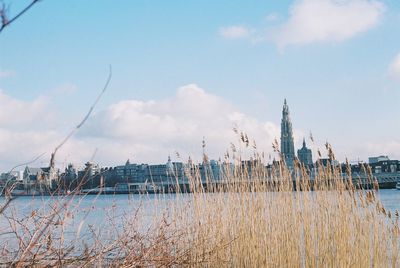 Panoramic view of lake and buildings against sky