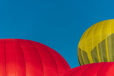 Low angle view of hot air balloon against clear blue sky