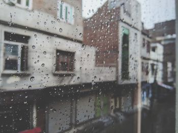 Buildings seen through wet window during rainy season