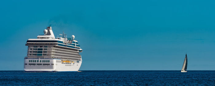 Sailboat sailing on sea against blue sky